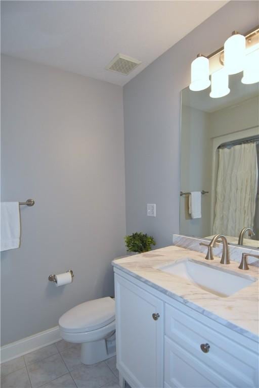 full bathroom featuring visible vents, vanity, tile patterned floors, baseboards, and toilet