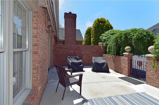 view of patio / terrace featuring grilling area and fence