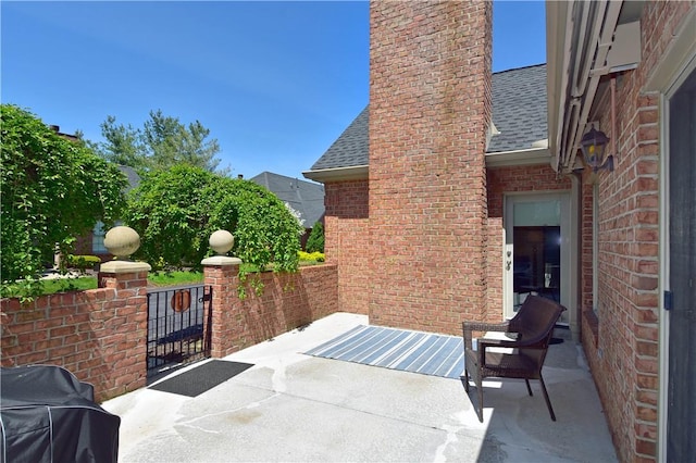 view of patio / terrace featuring a gate and a grill