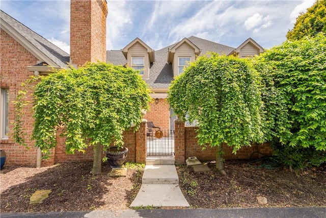 1501 Appleridge Ct, Adams Twp, PA 15044 - view of front of home with brick siding, a chimney, a gate, roof with shingles, and fence