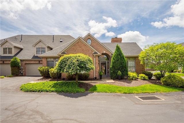 1501 Appleridge Ct, Adams Twp, PA 15044 - view of front facade featuring brick siding, driveway, a chimney, and a shingled roof