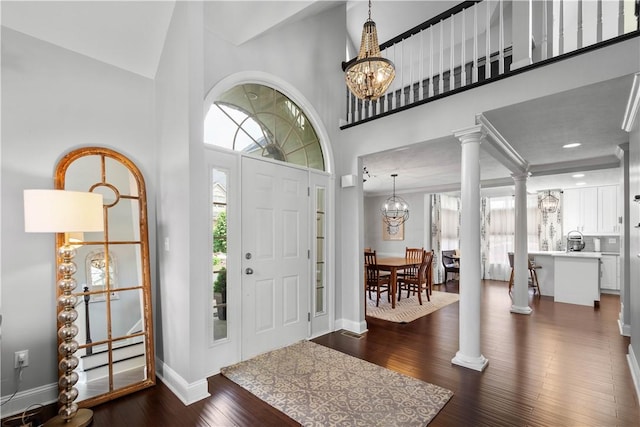 1501 Appleridge Ct, Adams Twp, PA 15044 - entryway featuring high vaulted ceiling, dark wood-type flooring, ornate columns, baseboards, and a chandelier