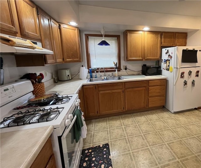 338 Prestley Rd, Bridgeville, PA 15017 - kitchen featuring brown cabinets, a sink, white appliances, light countertops, and under cabinet range hood