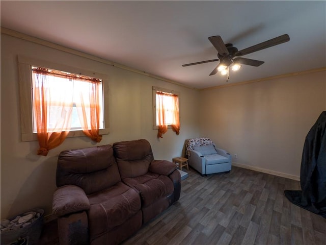 living room with baseboards, ceiling fan, and wood finished floors