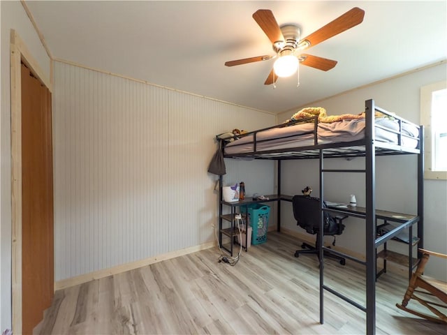 bedroom with baseboards, a ceiling fan, and wood finished floors