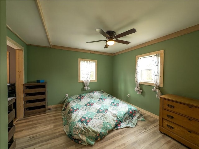 bedroom featuring baseboards, light wood-style flooring, and ceiling fan