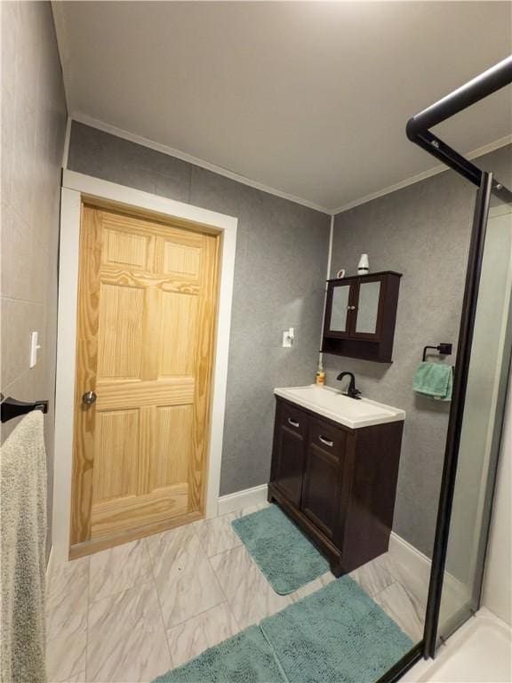 bathroom featuring ornamental molding, a shower stall, marble finish floor, and vanity