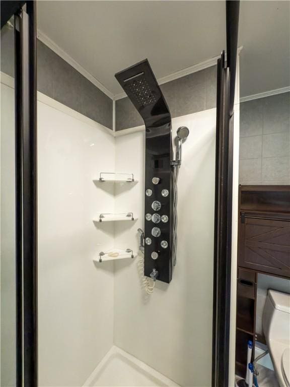 interior details with crown molding, a walk in shower, and toilet