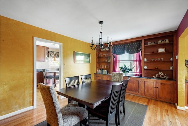 1427 Pueblo Dr, Mt Lebanon, PA 15228 - dining space featuring a chandelier, light wood finished floors, and baseboards