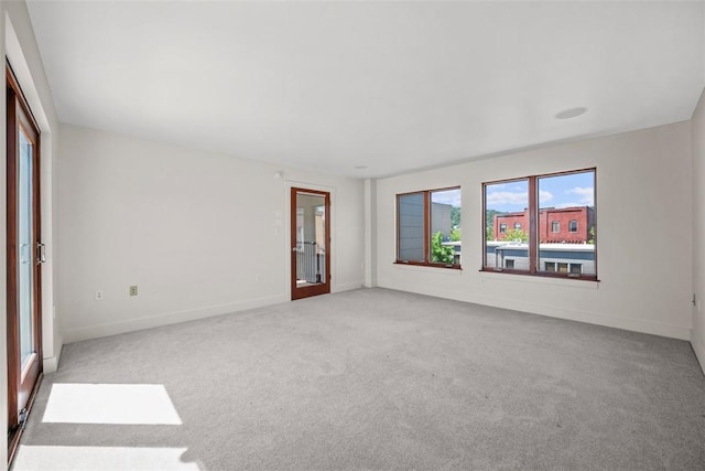 empty room with baseboards and carpet flooring