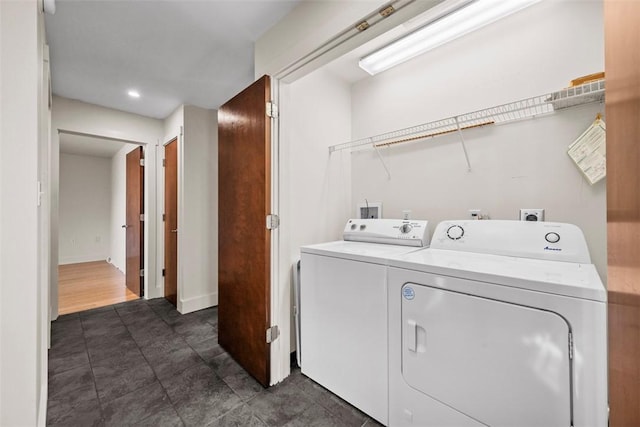 laundry room with separate washer and dryer, laundry area, recessed lighting, and dark tile patterned floors