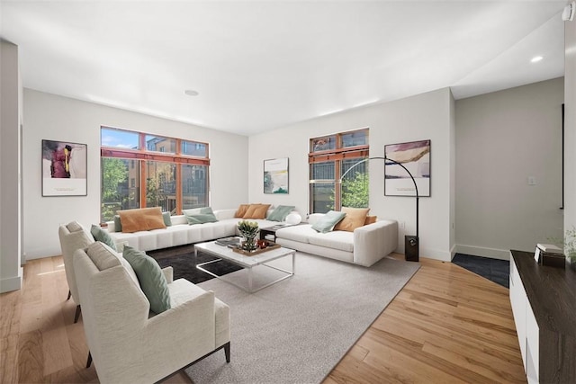 living area featuring baseboards, recessed lighting, and wood finished floors