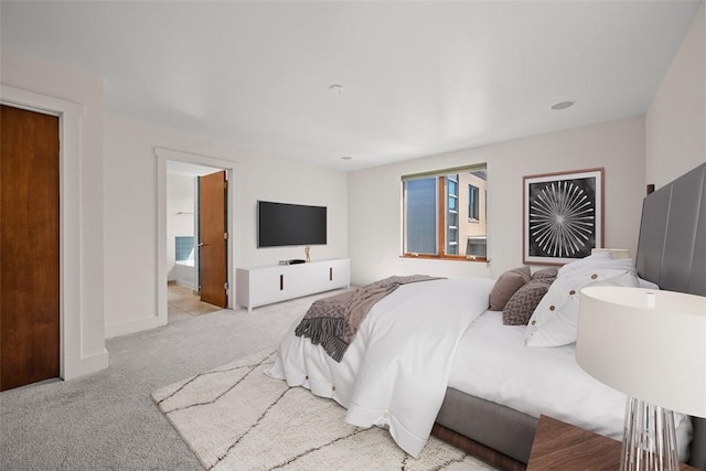 bedroom featuring baseboards, carpet flooring, and ensuite bath