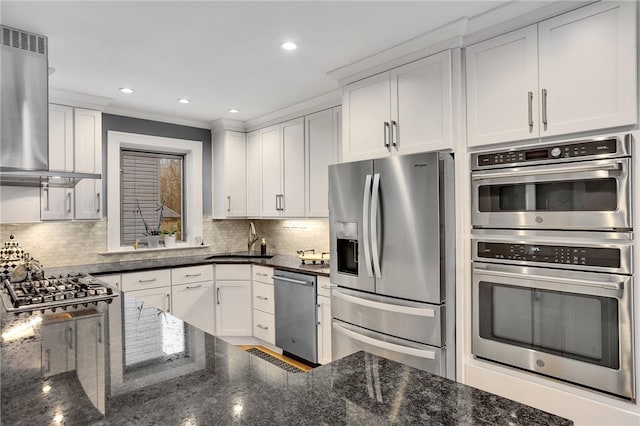 kitchen featuring a sink, dark stone counters, extractor fan, and stainless steel appliances