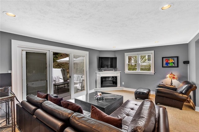 living area featuring plenty of natural light, recessed lighting, and a textured ceiling