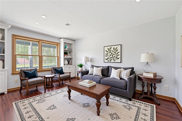 living room with visible vents, recessed lighting, baseboards, and wood finished floors