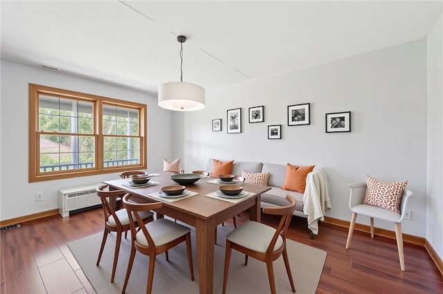 dining area with baseboards, visible vents, breakfast area, and wood finished floors