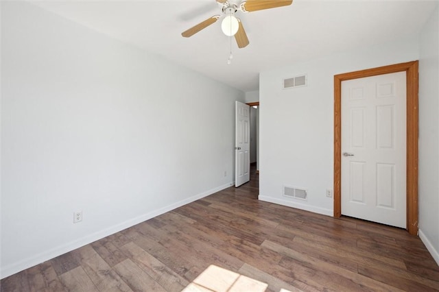 unfurnished bedroom featuring visible vents, baseboards, ceiling fan, and wood finished floors