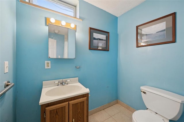 bathroom featuring toilet, baseboards, tile patterned flooring, and vanity