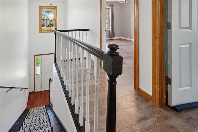 stairway featuring baseboards and wood finished floors