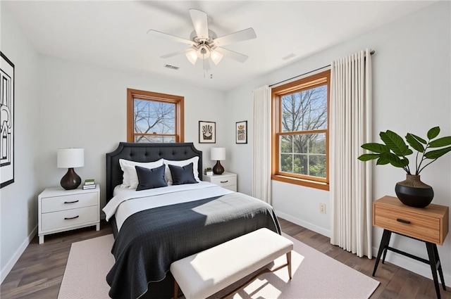 bedroom featuring visible vents, baseboards, ceiling fan, and dark wood-style floors
