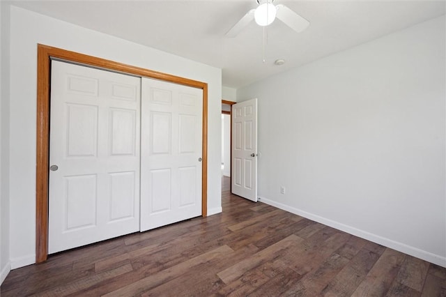 unfurnished bedroom with baseboards, wood finished floors, and a closet