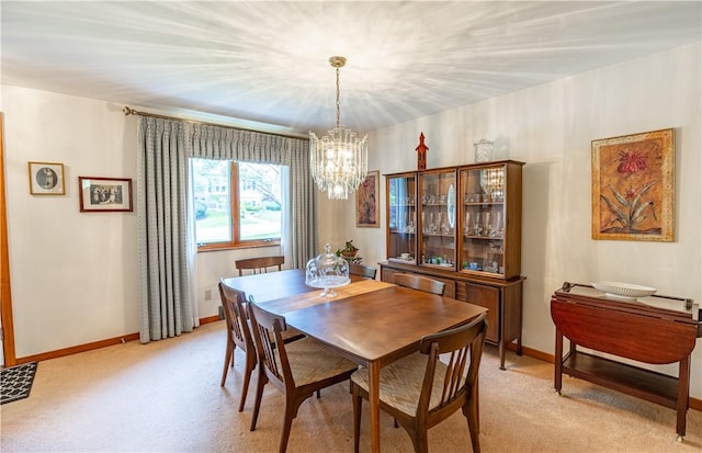 500 11th St, Oakmont, PA 15139 - dining space with light colored carpet, baseboards, and a notable chandelier