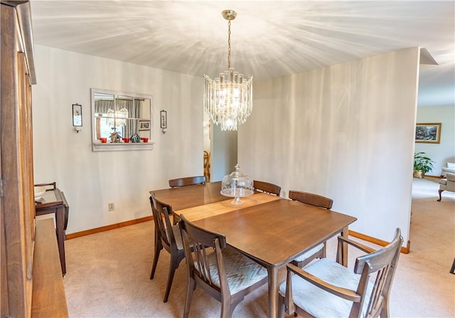 500 11th St, Oakmont, PA 15139 - dining space with light colored carpet, baseboards, and an inviting chandelier
