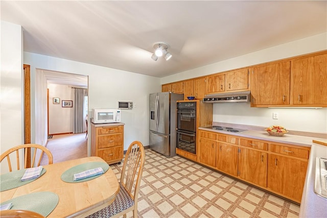 500 11th St, Oakmont, PA 15139 - kitchen featuring stainless steel fridge with ice dispenser, light countertops, dobule oven black, white microwave, and under cabinet range hood