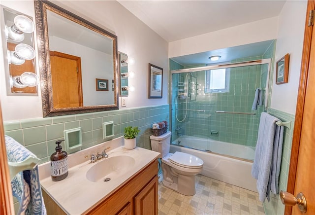 500 11th St, Oakmont, PA 15139 - bathroom with toilet, tile patterned floors, tile walls, and a wainscoted wall