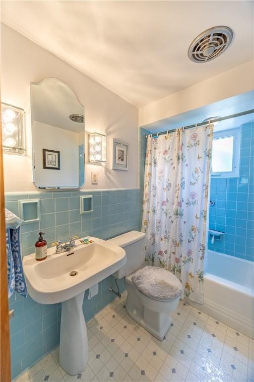 500 11th St, Oakmont, PA 15139 - full bathroom with shower / bath combo, toilet, tile patterned floors, tile walls, and visible vents