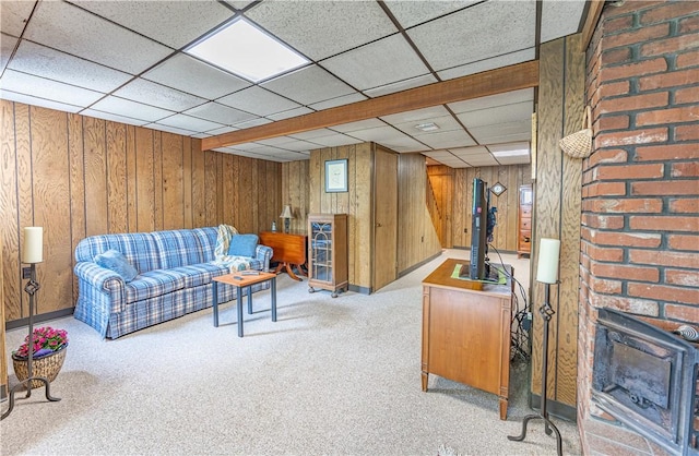500 11th St, Oakmont, PA 15139 - living room featuring wooden walls, a drop ceiling, carpet, and a wood stove