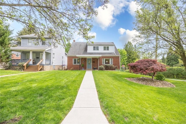 500 11th St, Oakmont, PA 15139 - view of front of home featuring covered porch, brick siding, and a front yard
