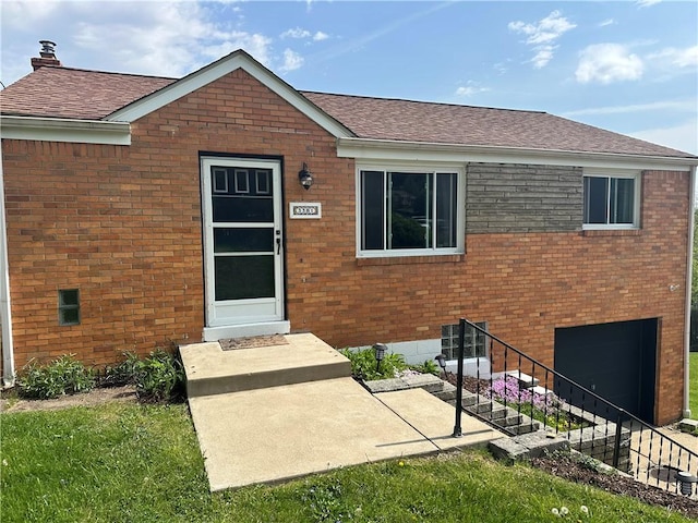 3381 Wallace Dr, Baldwin Boro, PA 15227 - view of exterior entry featuring a shingled roof, brick siding, a chimney, and a garage