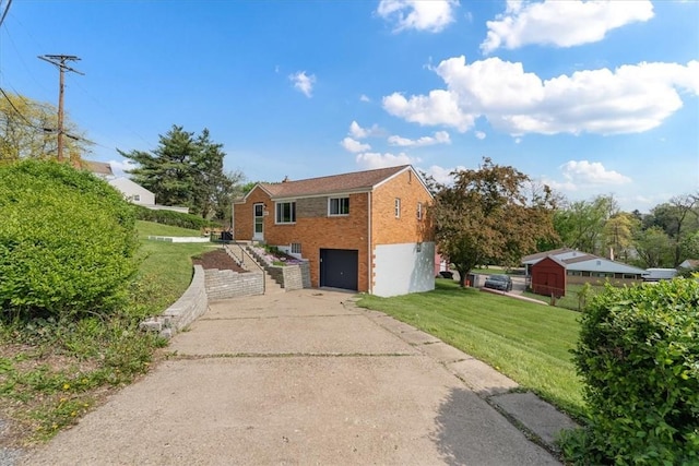3381 Wallace Dr, Baldwin Boro, PA 15227 - view of home's exterior featuring a lawn, brick siding, driveway, and a garage