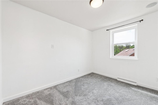 carpeted spare room featuring visible vents and baseboards