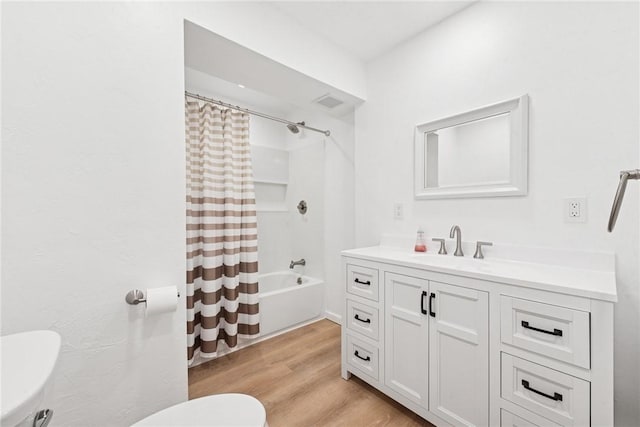 full bathroom featuring vanity, shower / tub combo with curtain, wood finished floors, and toilet