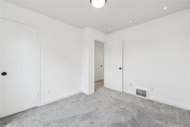 unfurnished bedroom featuring baseboards, carpet, recessed lighting, and visible vents