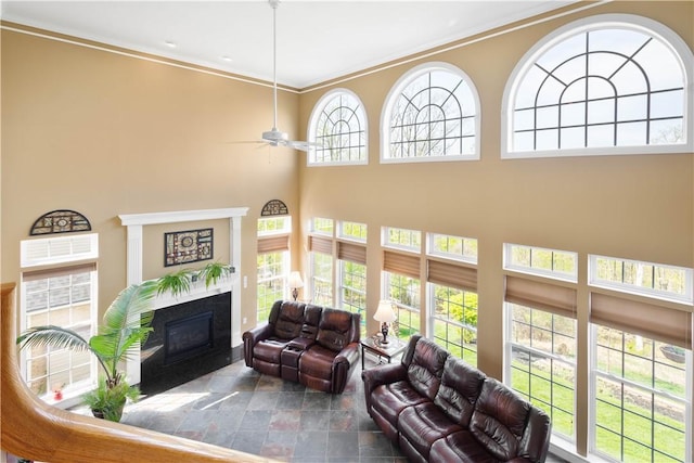342 Buffalo Ridge Rd, Peters Twp, PA 15317 - living room featuring ceiling fan, a high ceiling, stone finish floor, a fireplace with flush hearth, and ornamental molding