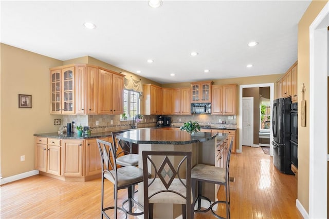 342 Buffalo Ridge Rd, Peters Twp, PA 15317 - kitchen with backsplash, a kitchen breakfast bar, black appliances, and a center island