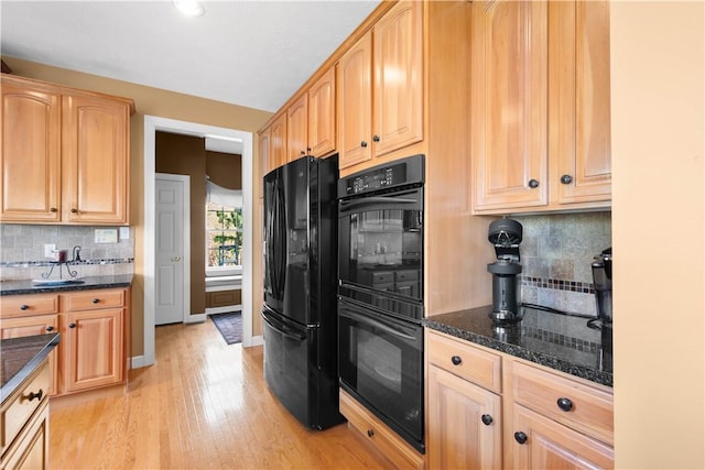 342 Buffalo Ridge Rd, Peters Twp, PA 15317 - kitchen with light brown cabinetry, tasteful backsplash, black appliances, dark stone countertops, and light wood-style floors