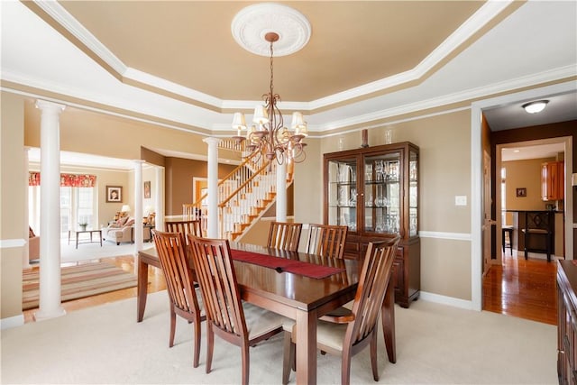342 Buffalo Ridge Rd, Peters Twp, PA 15317 - dining room with crown molding, light colored carpet, a chandelier, ornate columns, and a tray ceiling