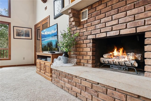 209 Claypoole Hill Rd, Bethel Twp, PA 16226 - living room with visible vents, a towering ceiling, light colored carpet, a brick fireplace, and baseboards