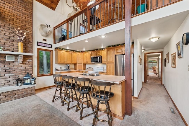 209 Claypoole Hill Rd, Bethel Twp, PA 16226 - kitchen featuring a sink, a breakfast bar area, light countertops, stainless steel appliances, and baseboards