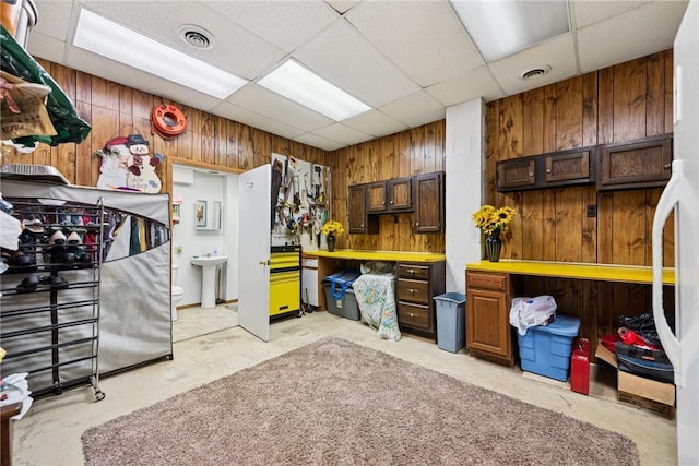 209 Claypoole Hill Rd, Bethel Twp, PA 16226 - interior space with a sink, wood walls, concrete floors, a drop ceiling, and visible vents