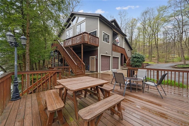 209 Claypoole Hill Rd, Bethel Twp, PA 16226 - wooden terrace with stairs, a garage, concrete driveway, and outdoor dining space
