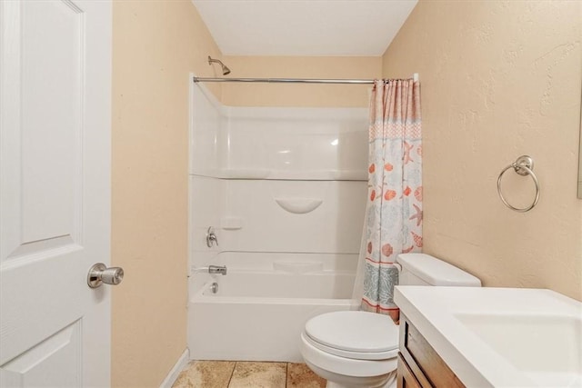 bathroom featuring vanity, a textured wall, shower / bath combination with curtain, and toilet