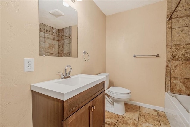bathroom with toilet, baseboards, washtub / shower combination, and vanity