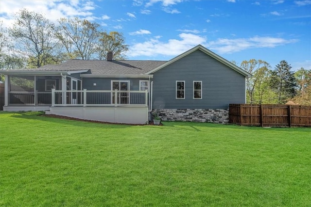 back of property featuring a sunroom, fence, a yard, and a chimney