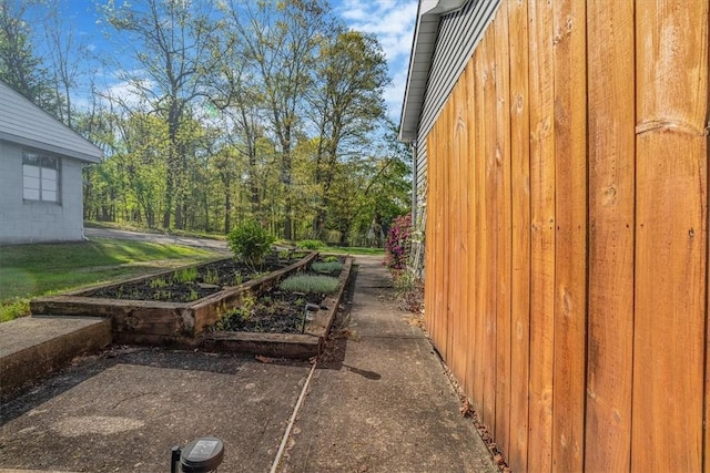 view of side of property featuring board and batten siding and a garden